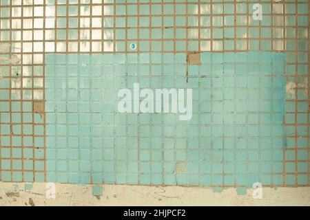 Texture of tile. Wall is in sunlight. Tiles in cladding of building. Small squares. Stock Photo
