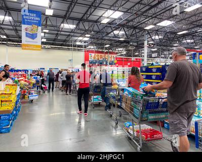 Orlando,FL USA - March 13, 2020:  People waiting in long lines waiting to check out at a Sams Club in Orlando, Florida. Stock Photo