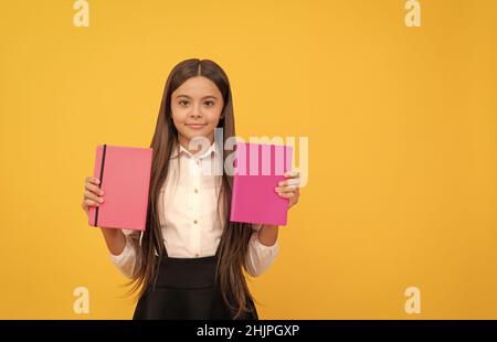 smiling teen girl hold books. nerd with planner notepad. back to school. education. book store. childrens literature. intellectual child reader. educa Stock Photo