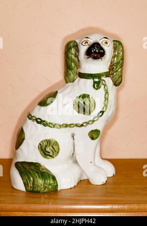 Antique Ceramic Staffordshire pot dog with green glaze highlights. Stock Photo