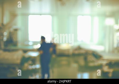 Working nurses on day shift in the intensive care unit, unfocused background. Stock Photo