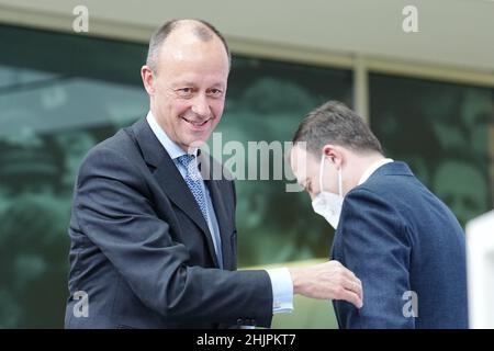 31 January 2022, Berlin: Friedrich Merz (l), new CDU party chairman, bids farewell to Paul Ziemiak, CDU member of the Bundestag and former CDU secretary-general, at the start of a press conference following the announcement of the postal election results for the CDU party leadership. Merz is now also officially the new CDU chairman. The 66-year-old economic politician received 95.33 percent of the vote in the postal ballot, according to CDU figures on Monday. This written vote was necessary for legal reasons after the online party conference on January 22. Photo: Kay Nietfeld/dpa Stock Photo