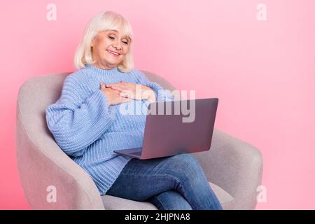 Portrait of attractive cheerful grey-haired woman calling video web cam talking isolated over pink pastel color background Stock Photo