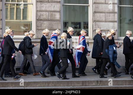 Flash-mob of 'partygate' anti-Boris Johnson protesters wearing floppy blond wigs and Boris Johnson facemasks outside the gates of Downing Street, UK Stock Photo