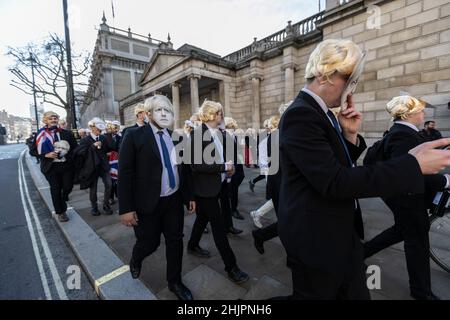 Flash-mob of 'partygate' anti-Boris Johnson protesters wearing floppy blond wigs and Boris Johnson facemasks outside the gates of Downing Street, UK Stock Photo