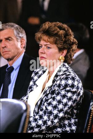 Virginia Thomas, wife of Judge Clarence Thomas, sheds a tear as she listens to senators question her husband on the charges leveled against him by Professor Anita Hill, during his confirmation hearing before the United States Senate Judiciary Committee on October 10, 1991 on Capitol Hill in Washington, DC. US Senator John Danforth (Republican of Missouri) is partially obscured at the left of the frame. Credit: Arnie Sachs/CNP Stock Photo