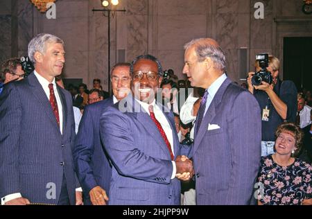 United States Senator Joseph Biden (Democrat of Delaware), Chairman, US Senate Judiciary Committee, second right, welcomes Judge Clarence Thomas, center, to the hearing before the US Senate Judiciary Committee to confirm him as Associate Justice of the US Supreme Court in the US Senate Caucus Room in Washington, DC on September 10, 1991. Pictured from left to right: US Senator John Danforth (Republican of Missouri); US Senator Strom Thurmond (Republican of South Carolina), Ranking Member; Judge Thomas; Chairman Biden; and Virginia Thomas, wife of the nominee, can be seen in the lower right c Stock Photo