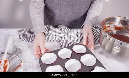 Step by step. Scooping batter with a cupcake scoop to make unicorn  chocolate cupcakes with buttercream frosting Stock Photo - Alamy