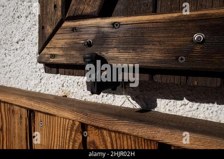 man-shaped shutter stop with stop stop, wooden detail at the dondena refuge in the aosta valley, italy Stock Photo