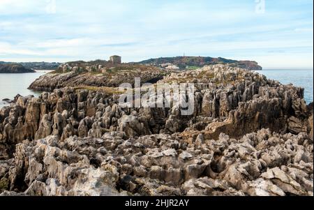 Rock formations of the Island of San Pedro and Islita de la Oliva on Noja beach in Cantabria, Northern Spain Stock Photo