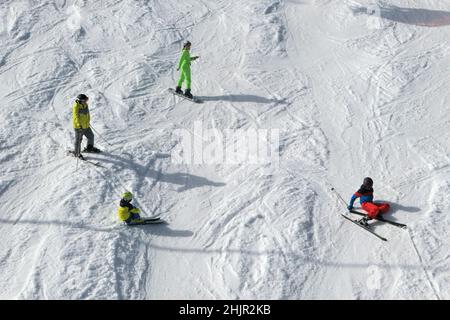Bialka Tatrzanska, Poland - February 23, 2021: Skiers skiing at the ski slope in popular winter resort Kotelnica Bialczanska. Winter holidays. Stock Photo