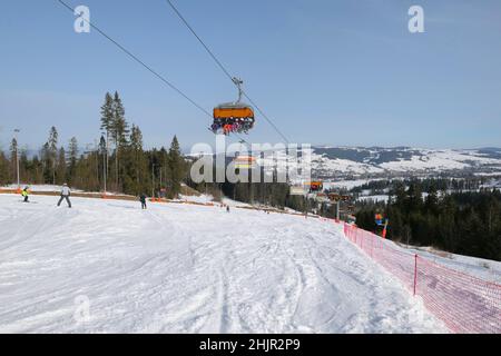 Bialka Tatrzanska, Poland - February 23, 2021: Ski slope in popular winter resort Kotelnica Bialczanska in polish mountains, Podhale region. Stock Photo