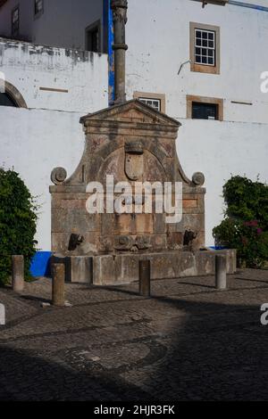 Mannerist or late Renaissance drinking fountain, commissioned 1575, in main square at Óbidos, Portugal Stock Photo