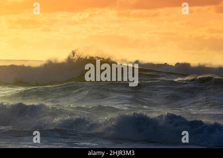 Misty Sunset over Waves on North Shore of Oahu Stock Photo