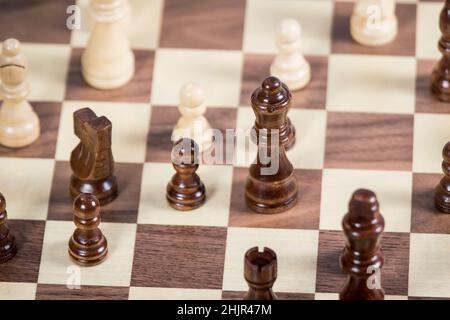 Chess board with Queen in focus, surrounded by pawns, knight and bishop Stock Photo