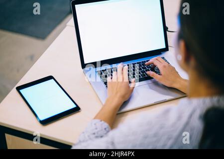 Anonymous female using netbook for work Stock Photo