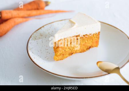 Carrot cake with cream cheese on top on a bright white backround Stock Photo