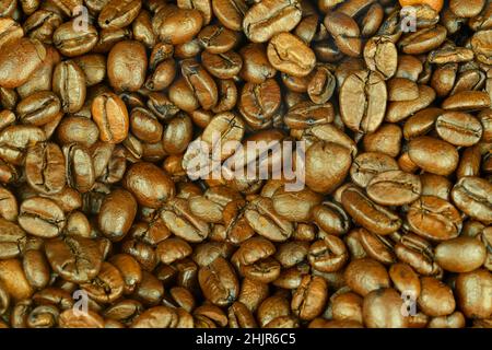 Golden roasted coffee beans background. Coffee beans background. The view from top. Flat lay Stock Photo