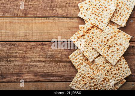 Matzah. Traditional ritual Jewish bread on old wooden rustic background. Passover food. Pesach Jewish holiday of Passover celebration concept. Stock Photo