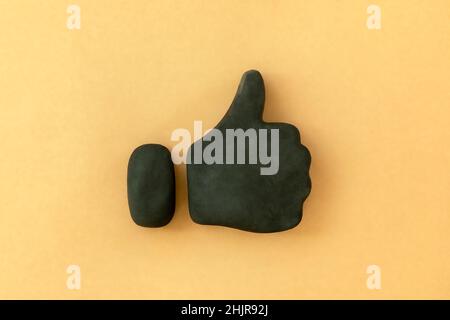 Thumbs up symbol. 3d icon shape of black thumb up sign on neutral background. Concept of success and approval. Stock Photo