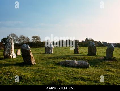 Duloe stone circle, Cornwall, England, UK, looking SW to the church. The smallest circle in Cornwall: 8 irregularly-shaped quartz stones form an oval. Stock Photo