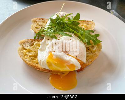 Poached eggs on toasted bread Stock Photo