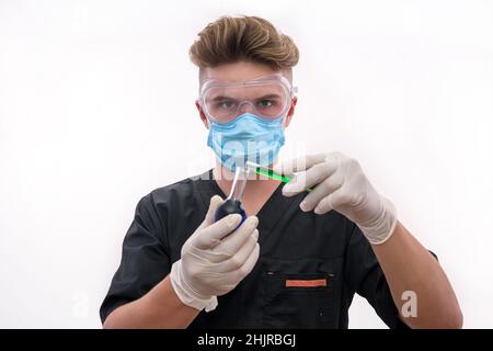 Handsome man chemist with flask making experiment in laboratory Stock Photo