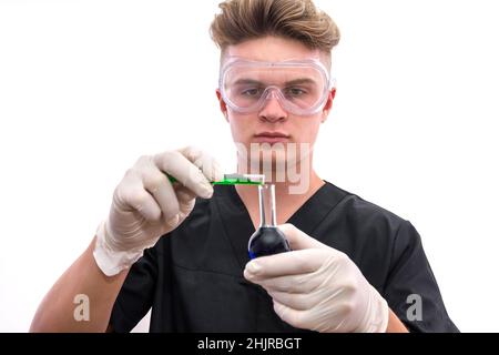 Handsome man chemist with flask making experiment in laboratory Stock Photo