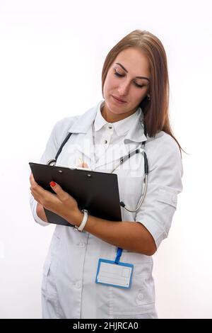 Doctor with clipboard. Pretty woman in medical uniform holding clipboard isolated on white Stock Photo