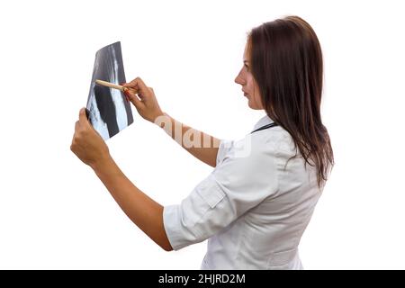Doctor examining x-ray. Beautiful woman in medical coat with patient's x-ray isolated on white Stock Photo