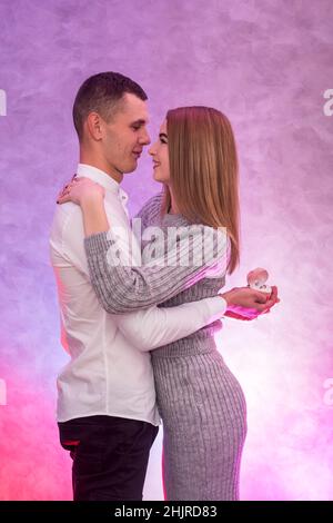 Young man making proposal with gold ring with diamond to his girl. Valentine's surprise Stock Photo