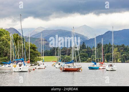 Yachts on Ullswater in the English Lake District looking towards Helvellyn under heavy cloud, Cumbria UK Stock Photo