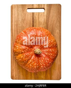 Textured decorative pumpkin on cutting board isolated on white background Stock Photo