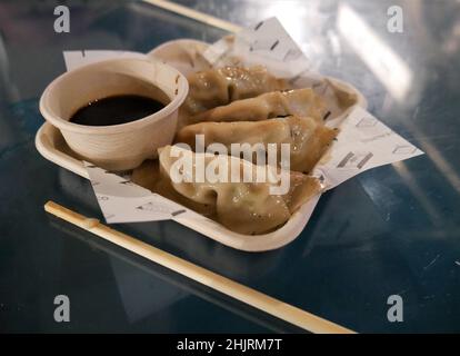 Gyozas and soy sauce dip on recyclable  paper and tray Stock Photo