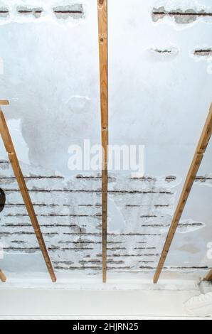 mold damage weathered roof house cement disintegration rusty iron frames inside Stock Photo