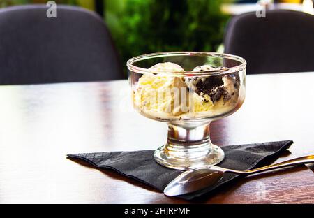 Lemon ice cream and biscuits in a transparent vase on a napkin Stock Photo