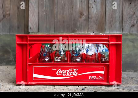 tokyo, japan - november 13 2021: Used and empty glass bottles of soda drinks like coca-cola or Japanese carbonated soft drink Ramune in a plastic mesh Stock Photo