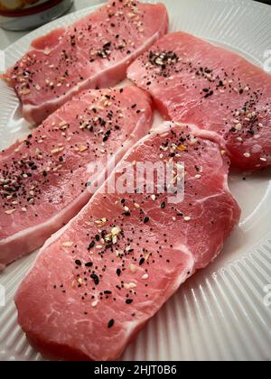 Pork medallions ready to cook on aWhite Plate, USA, 2022 Stock Photo