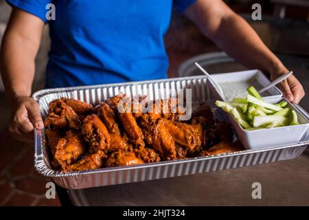 Large tray of buffalo wings with celery and blue cheese Stock Photo