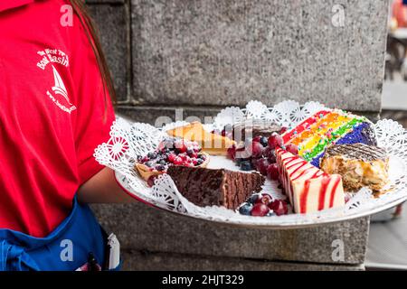 New York City, USA - September 14, 2019: Waiter holding dessert tray, The 79th Street Boat Basin Café. Stock Photo