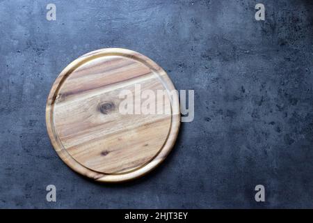 Rustic Handmade Round Wooden Chopping Board on Granite Stock Photo