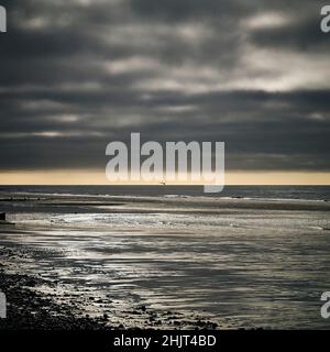 Storm approching over empty beach in winter Stock Photo