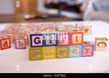 Word Girl Power written on a wood block on a white table at home Stock Photo