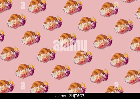 Trendy pattern made of freshly baked croissant with flowers on pink background. Minimal spring or summer concept. Modern fun concept of stylish food, Stock Photo