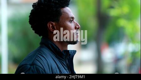 Pensive black african man smoking cigarette outdoors Stock Photo