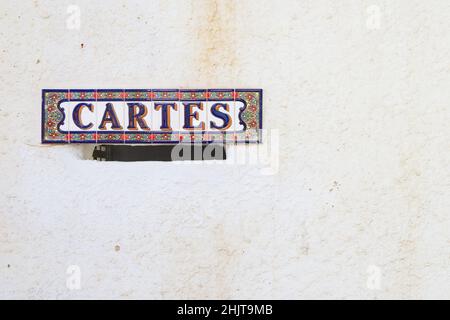 Close-up of a mailbox in the entrance wall of a residence that has the word "Letters" written in Catalan (cartes) with copy space on the decorated whi Stock Photo