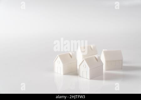 Miniature 3D printed model house on white background Stock Photo