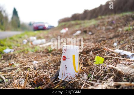 Litter on the side of a UK road including rubbish from major, takeaway restaurant. Stock Photo