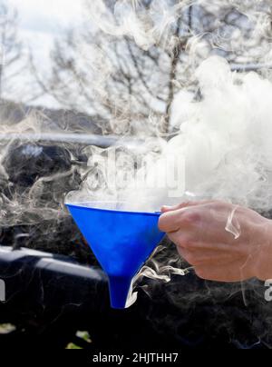 A funnel full of smoke and clouds blows in the wind Stock Photo