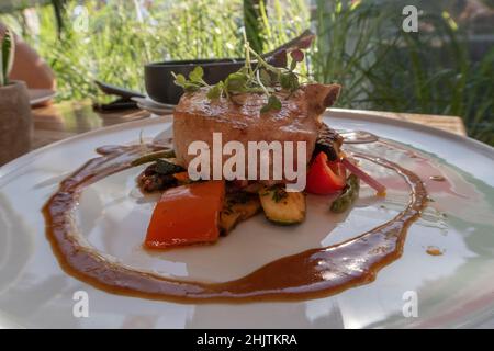Perfectly prepared Iberian pork chops with fried vegetables Stock Photo